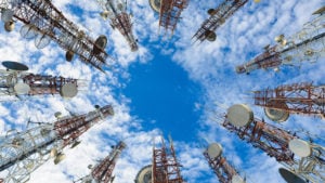 a ground-up view of multiple cell towers in a circle