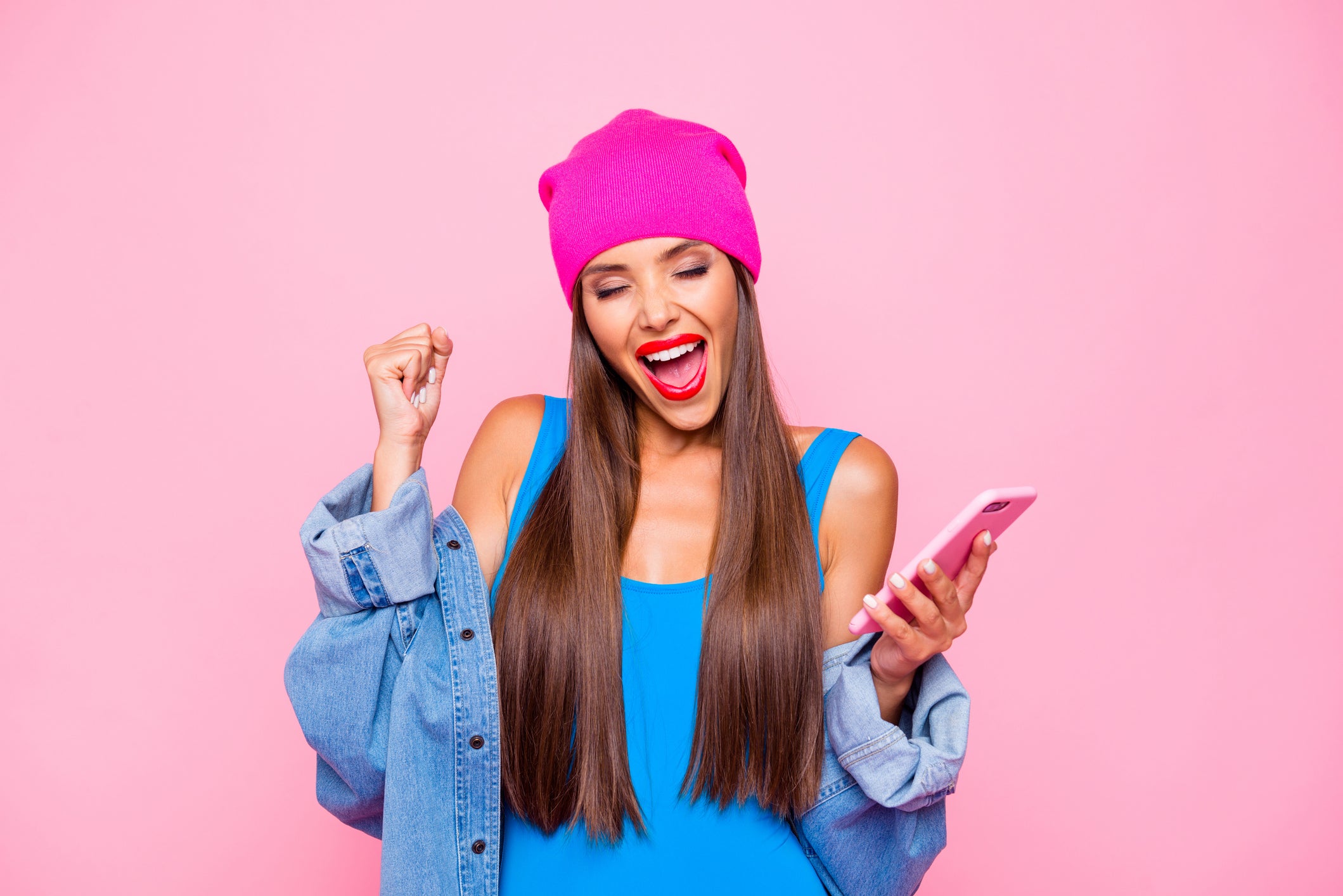 Someone delighted while holding a wireless phone.