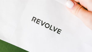 The Revolve (RVLV) group logo is seen on a display.