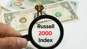 Russell 2000 Index. Magnifying glass showing the words. Background of banknotes and coins. Basic concepts of finance. Business theme. Financial terms.