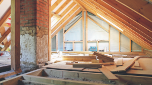 an interior view of a house attic under construction. Home Improvement Stocks