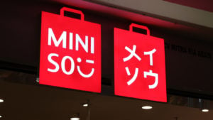 red Miniso (MNSO) sign glowing at night