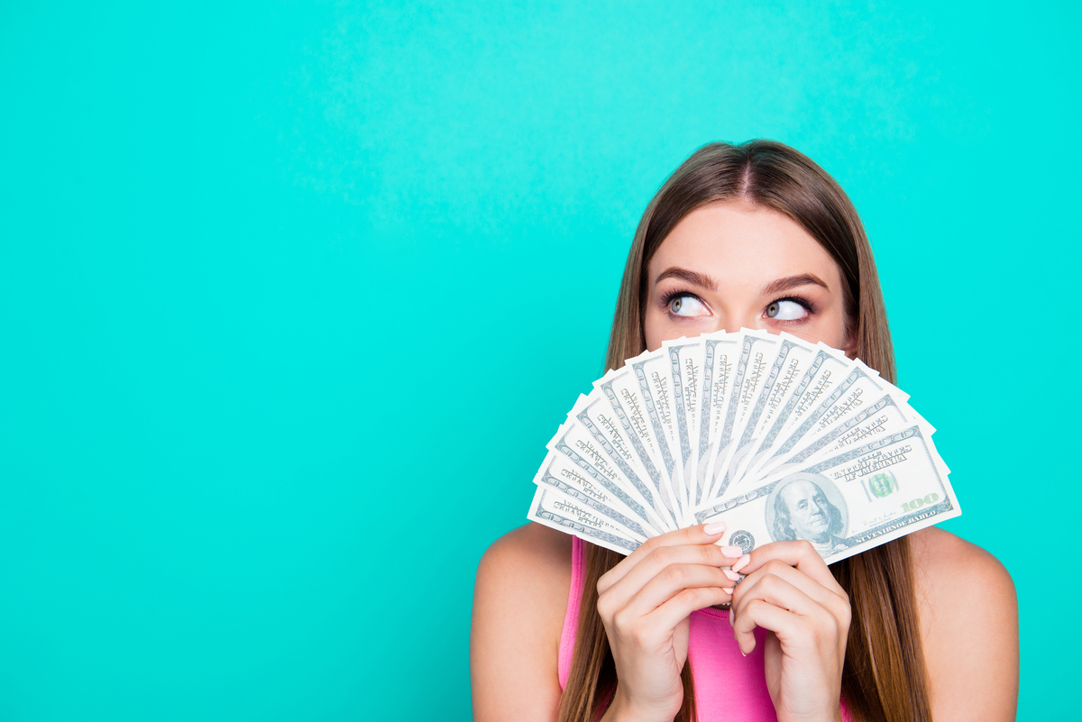 A woman holding cash. 