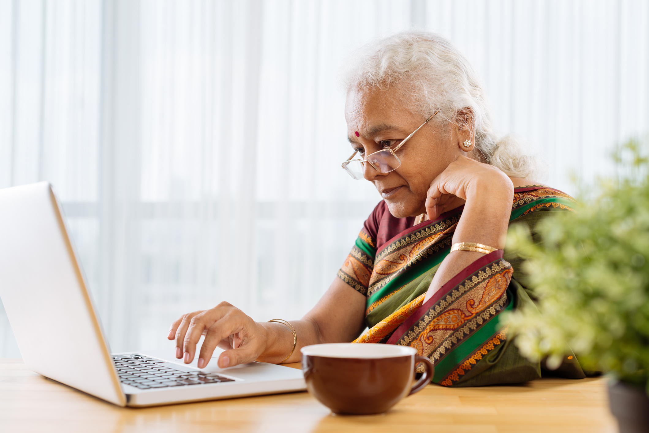 Curious person looking at laptop.