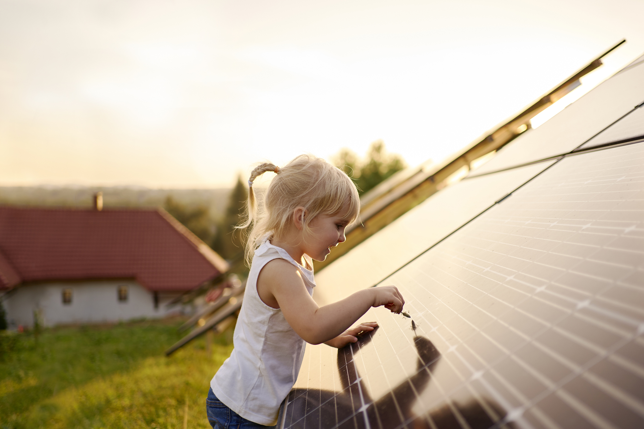 A child looking at a solar panel.