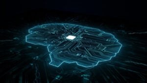 Black and cyber blue illustration of brain made out of light of circuit board with chip at the center of the brain, representing artificial intelligence (AI) stocks. AI Stocks to Sell