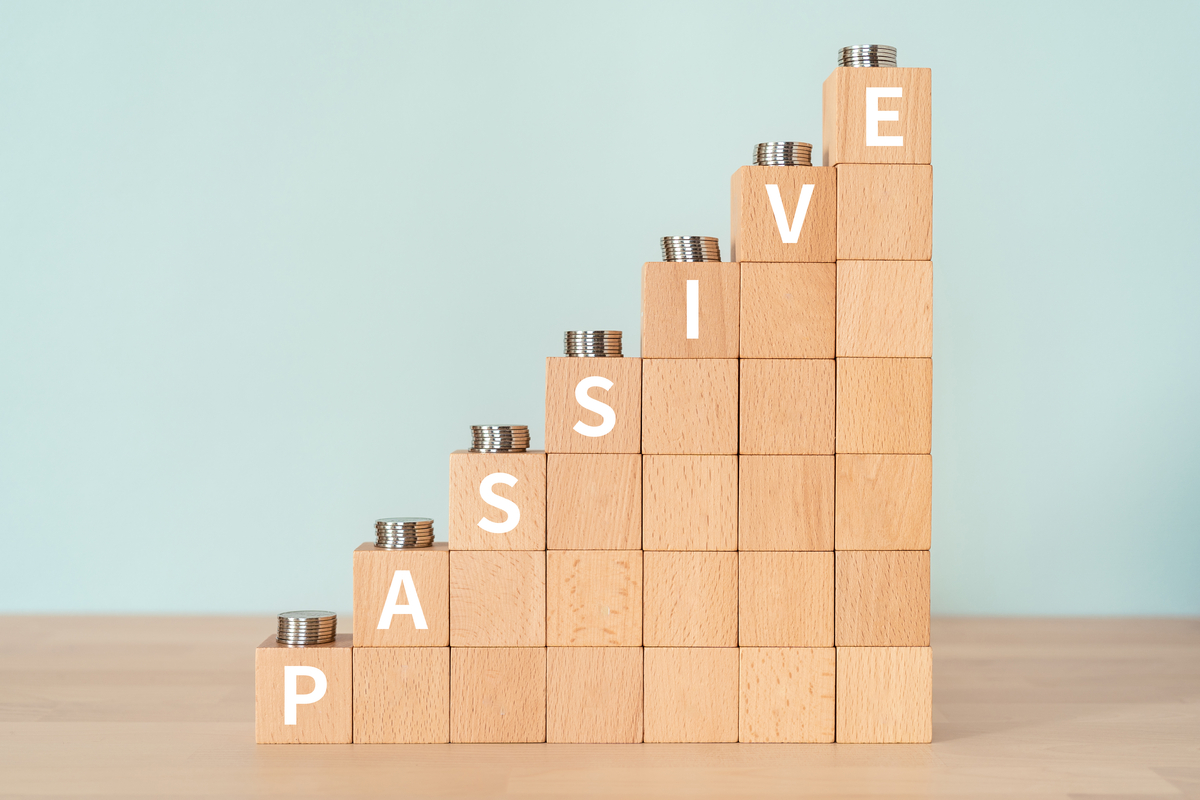 Block towers of increasing height spelling the word Passive. Coins sit atop each tower.