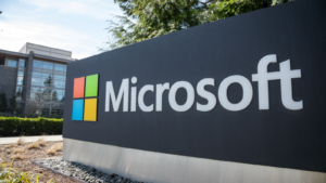 Wide angle view of a Microsoft sign at the headquarters for personal computer and cloud computing company, with office building in the background.. MSFT stock