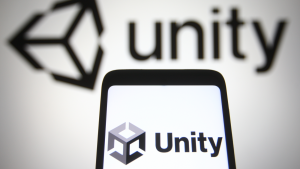 In this photo illustration Unity Software Inc. (U stock) logo is seen on a mobile phone and a computer screen.