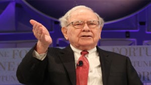 Warren Buffett gestures to an audience. Warren Buffett stocks to buy