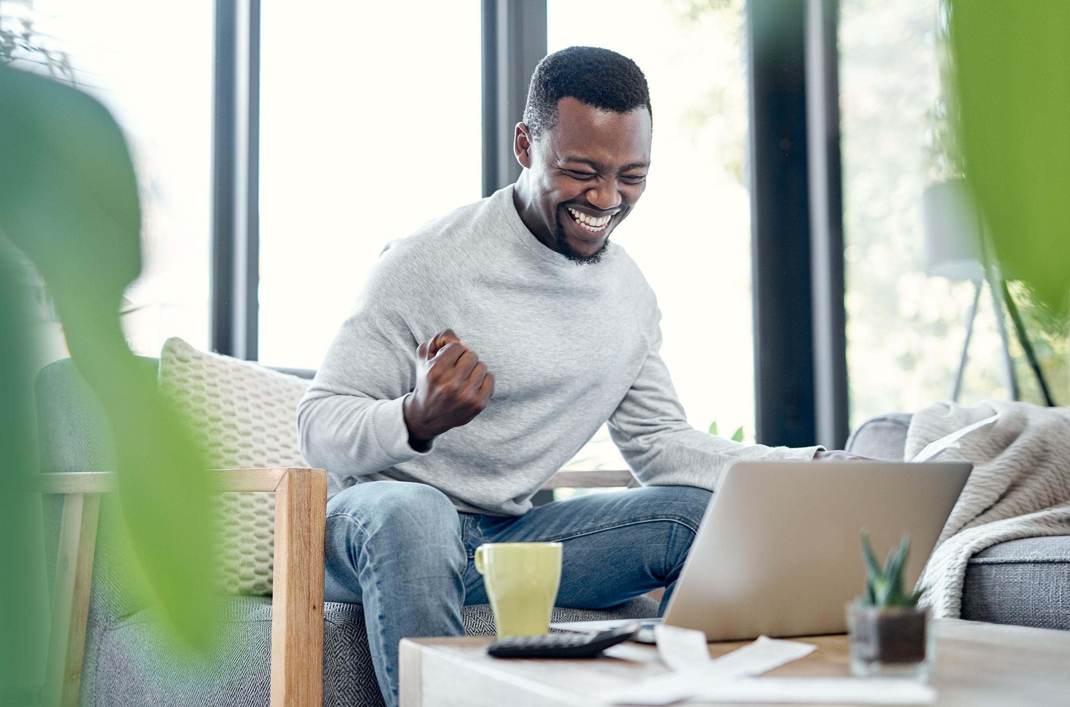 A person celebrating in front of a computer.