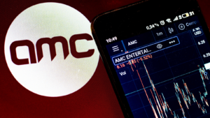 In this photo illustration the stock market information of AMC Entertainment Holdings, Inc. displays on a smartphone while the logo of AMC Entertainment Holdings, Inc. APE stock