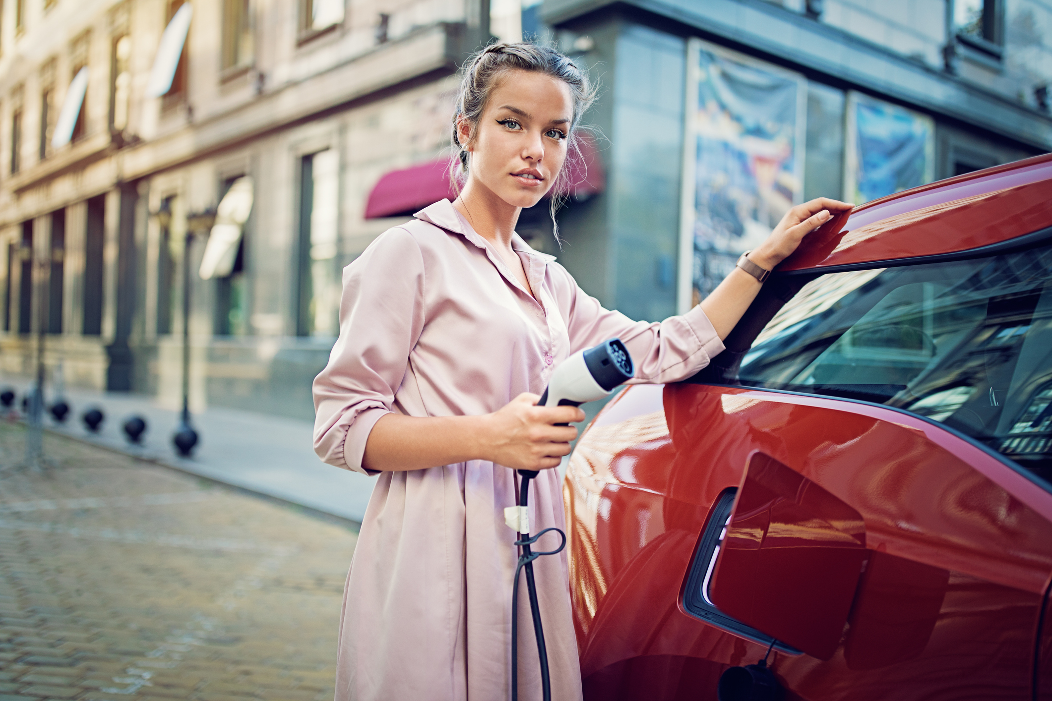 A driver charging an electric vehicle. 