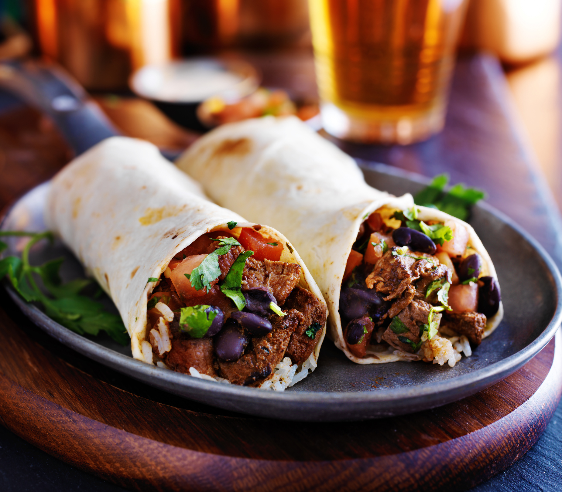 Two burritos on a plate. 