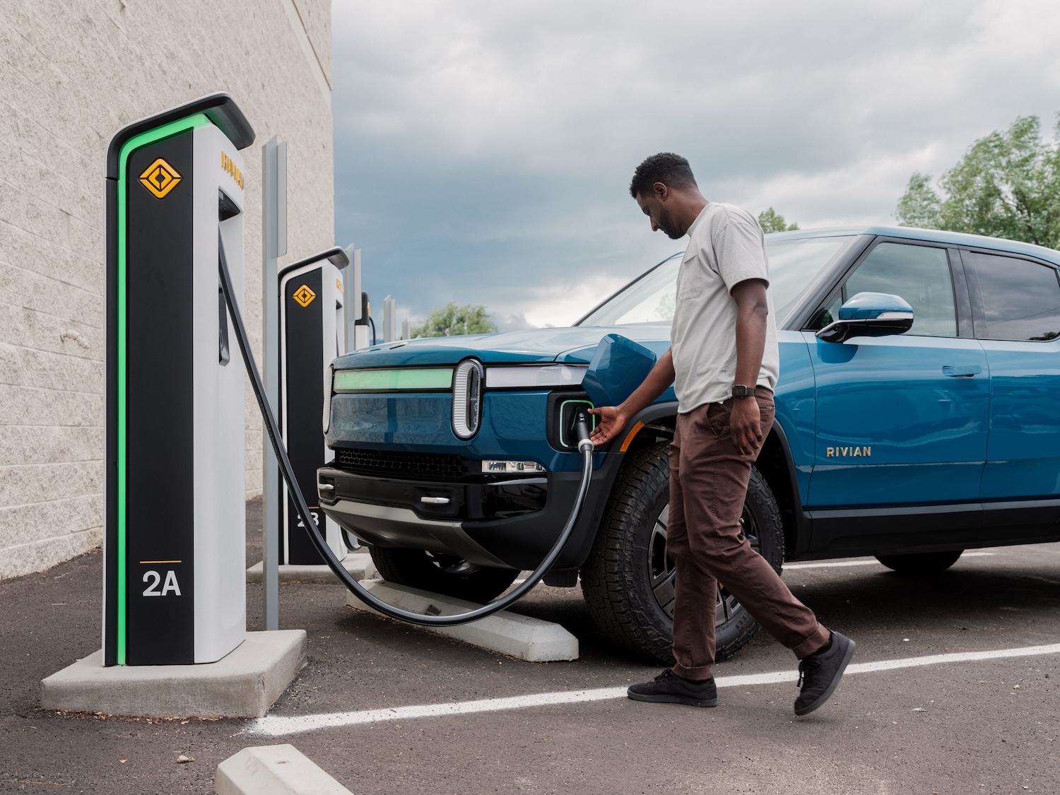 A person charging a vehicle.