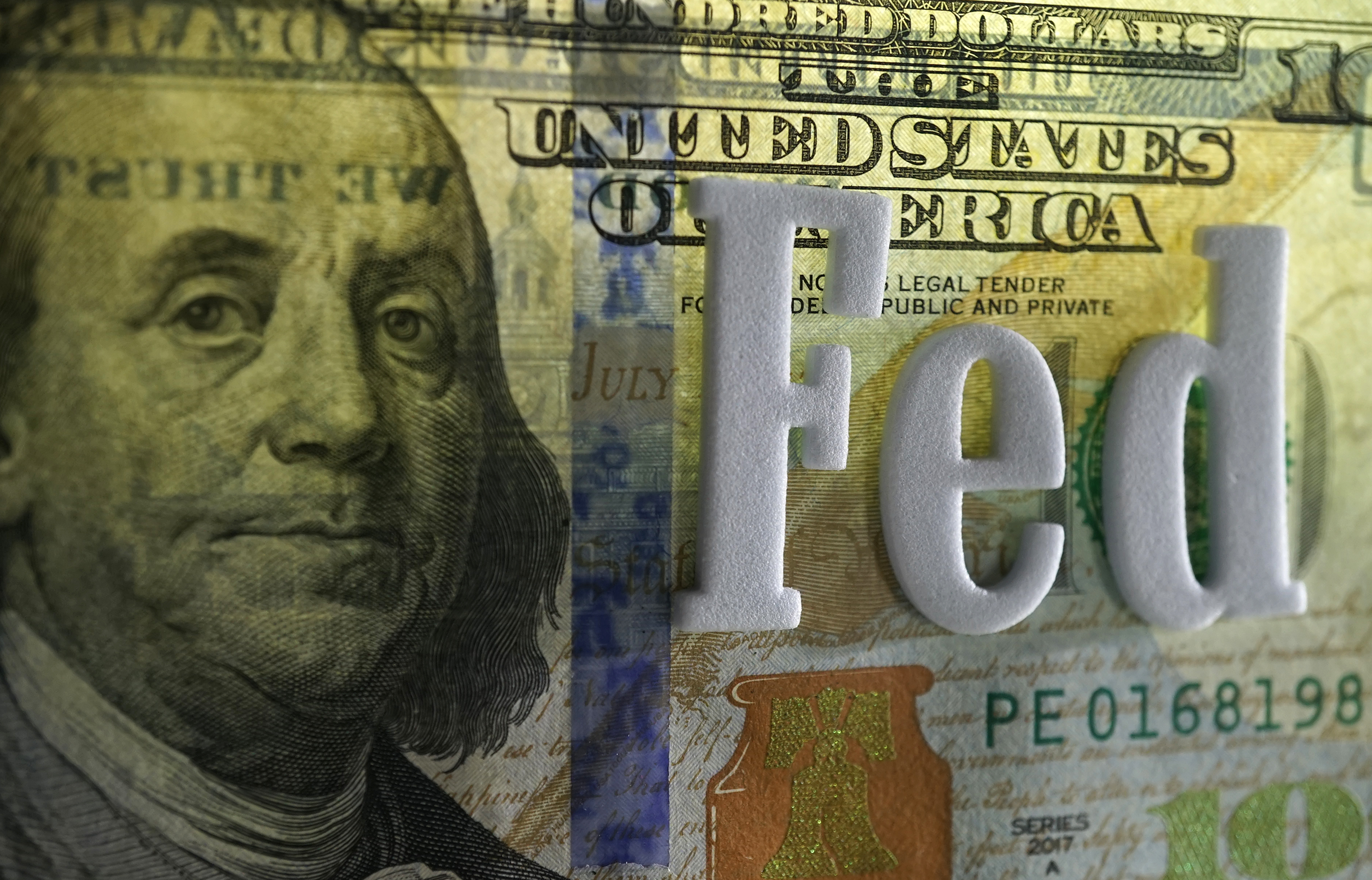 The word "Fed" over a $100 bill.