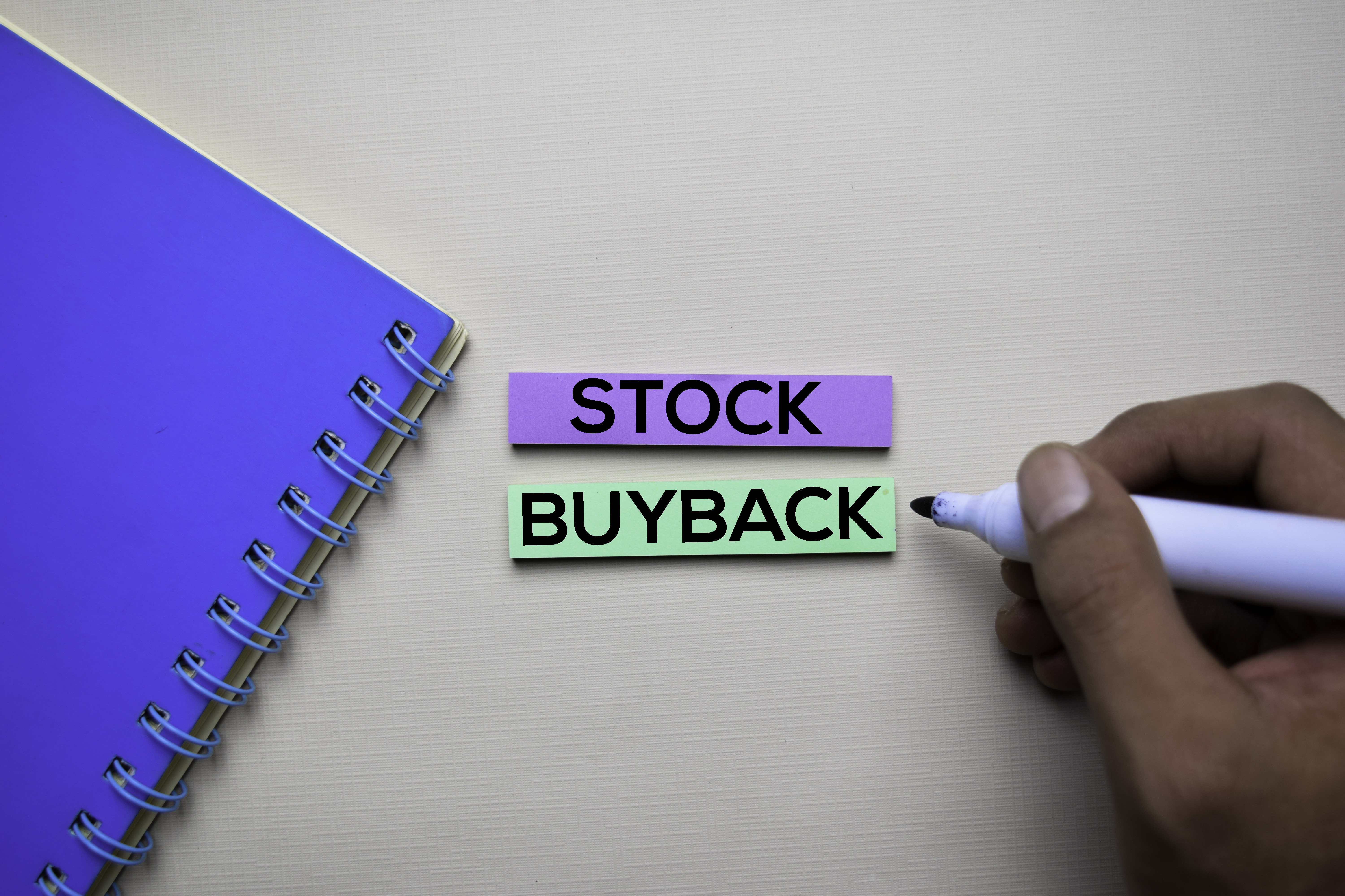 Stock Buyback written on a notecard. 