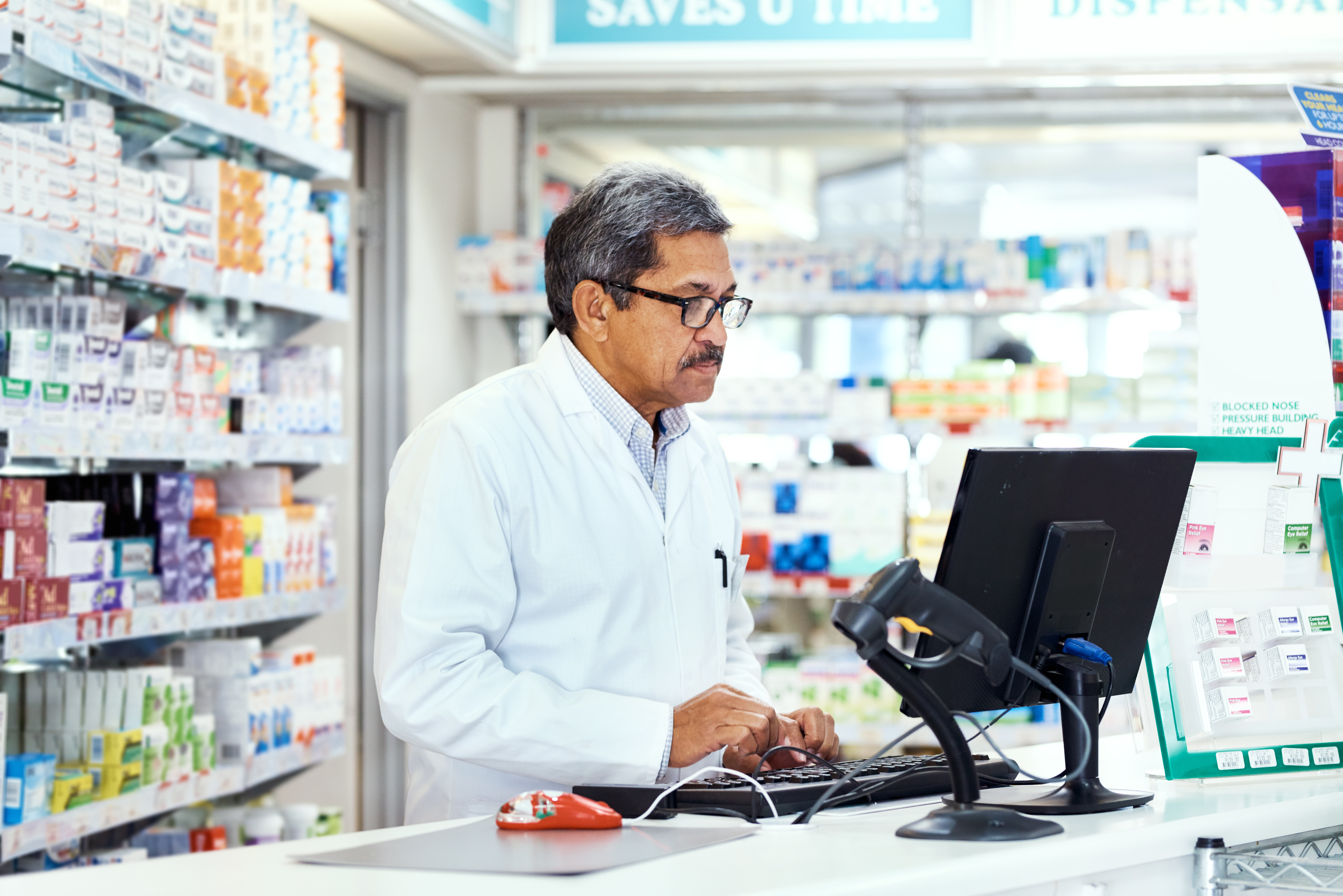 Pharmacist at counter.