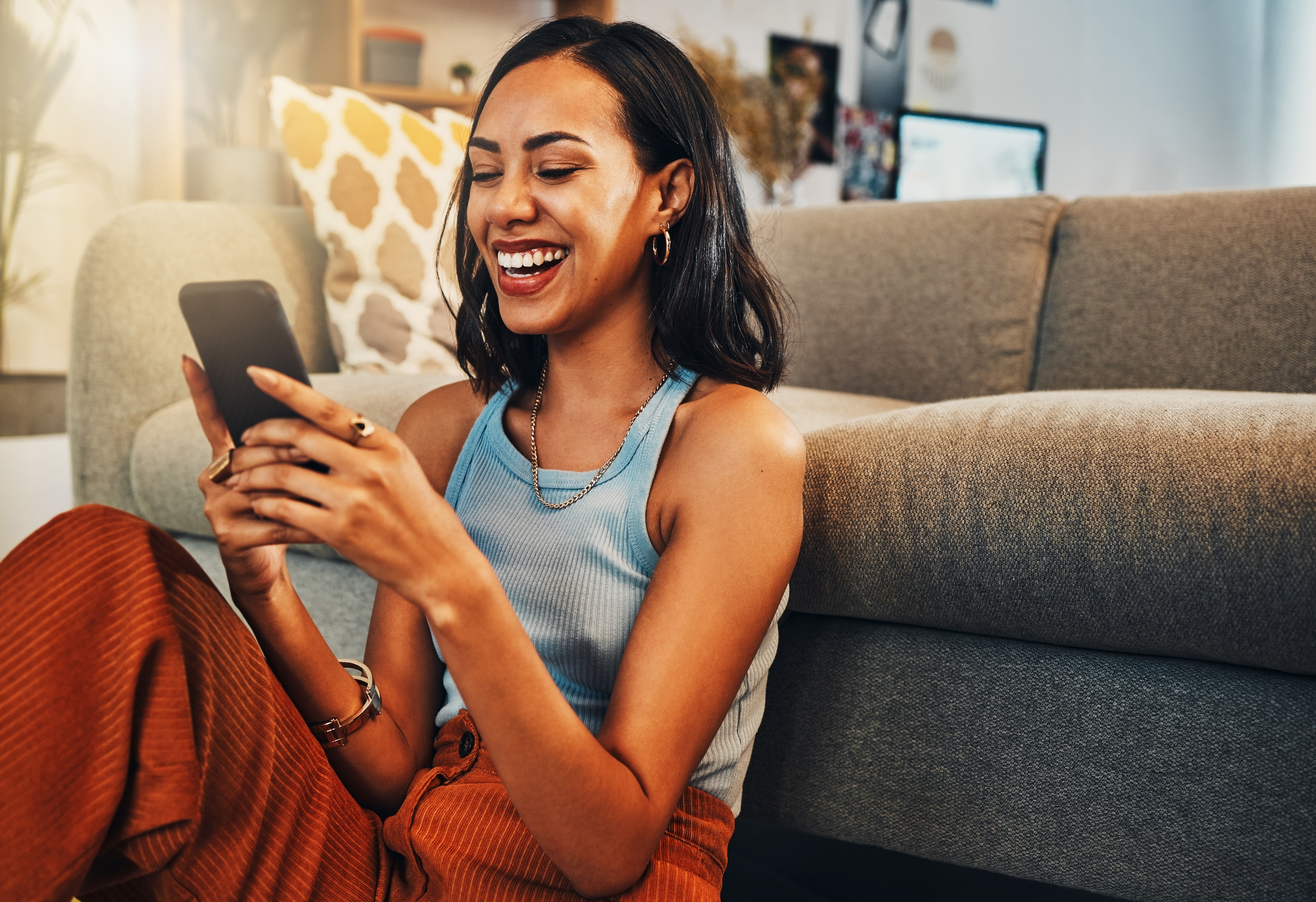 Smiling person looking at smartphone.