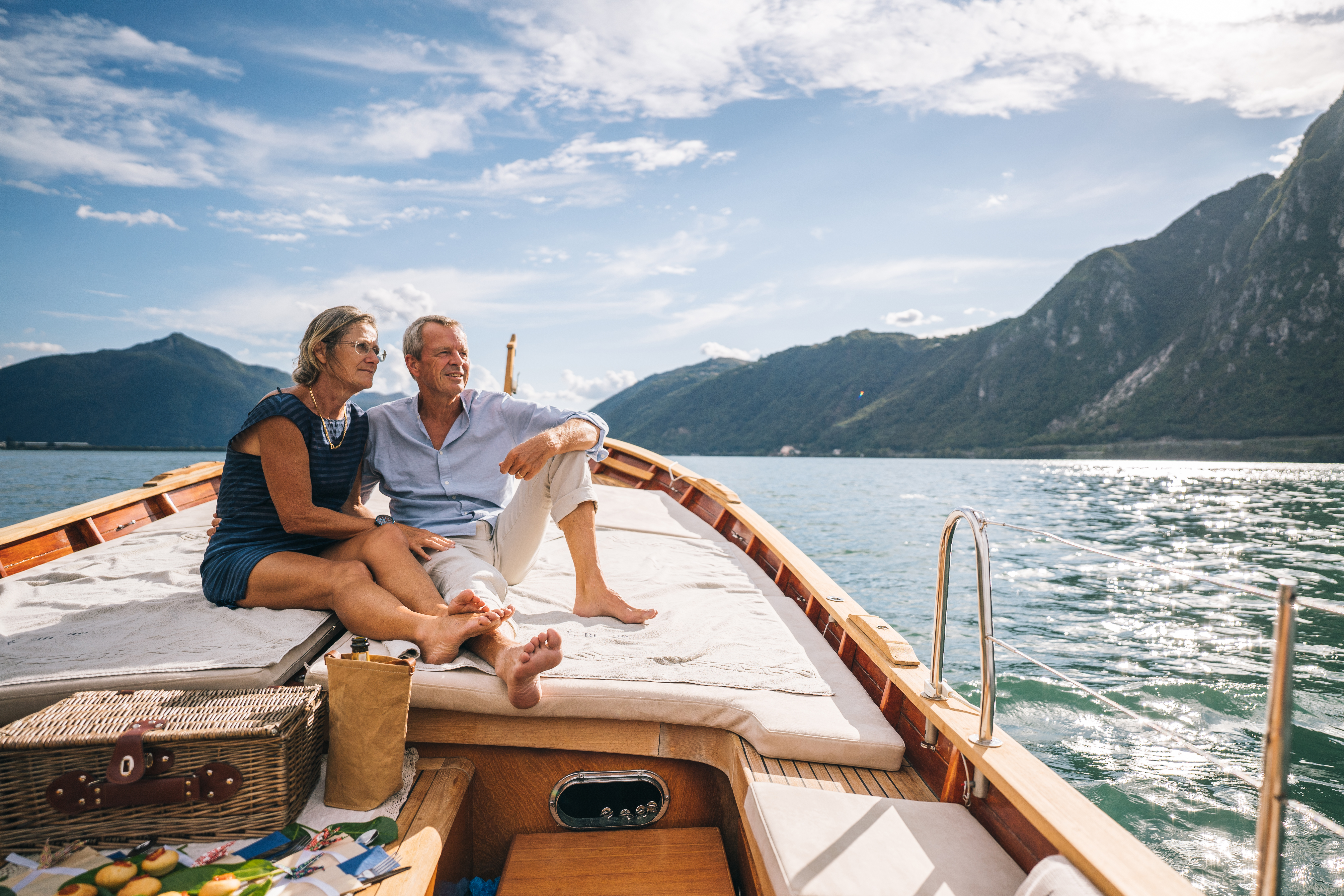 Two people sitting on boat, looking out over the water.