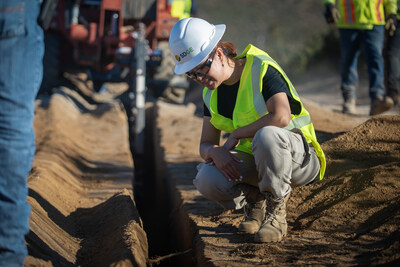 An SDG&E employee inspects a trench at a strategic undergrounding site in Ramona, California. Undergrounding power lines is crucial for enhancing energy reliability, reducing outages, and protecting communities from wildfire risk.