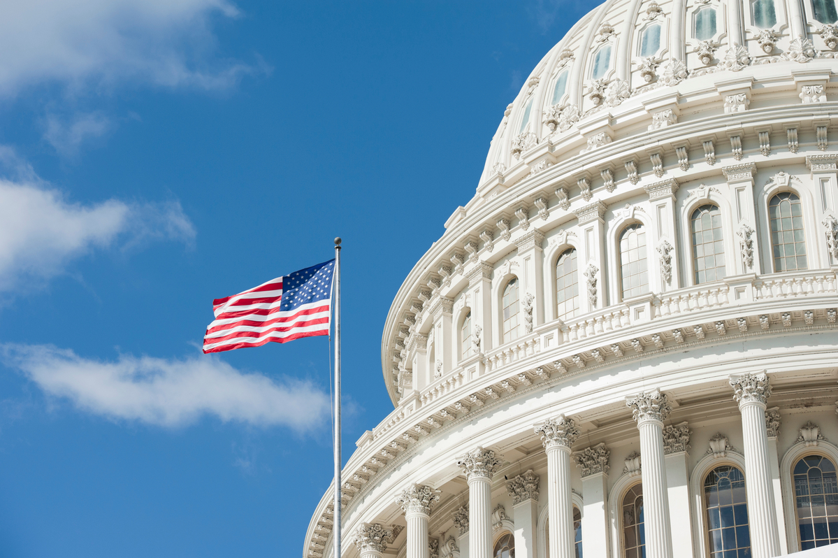 The Capitol dome with an American flag next to it.