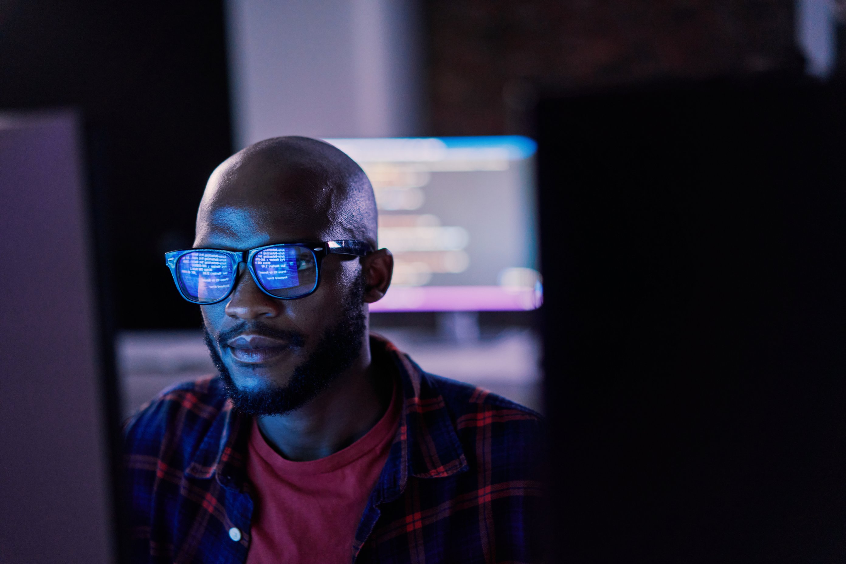 An IT professional working at a computer.