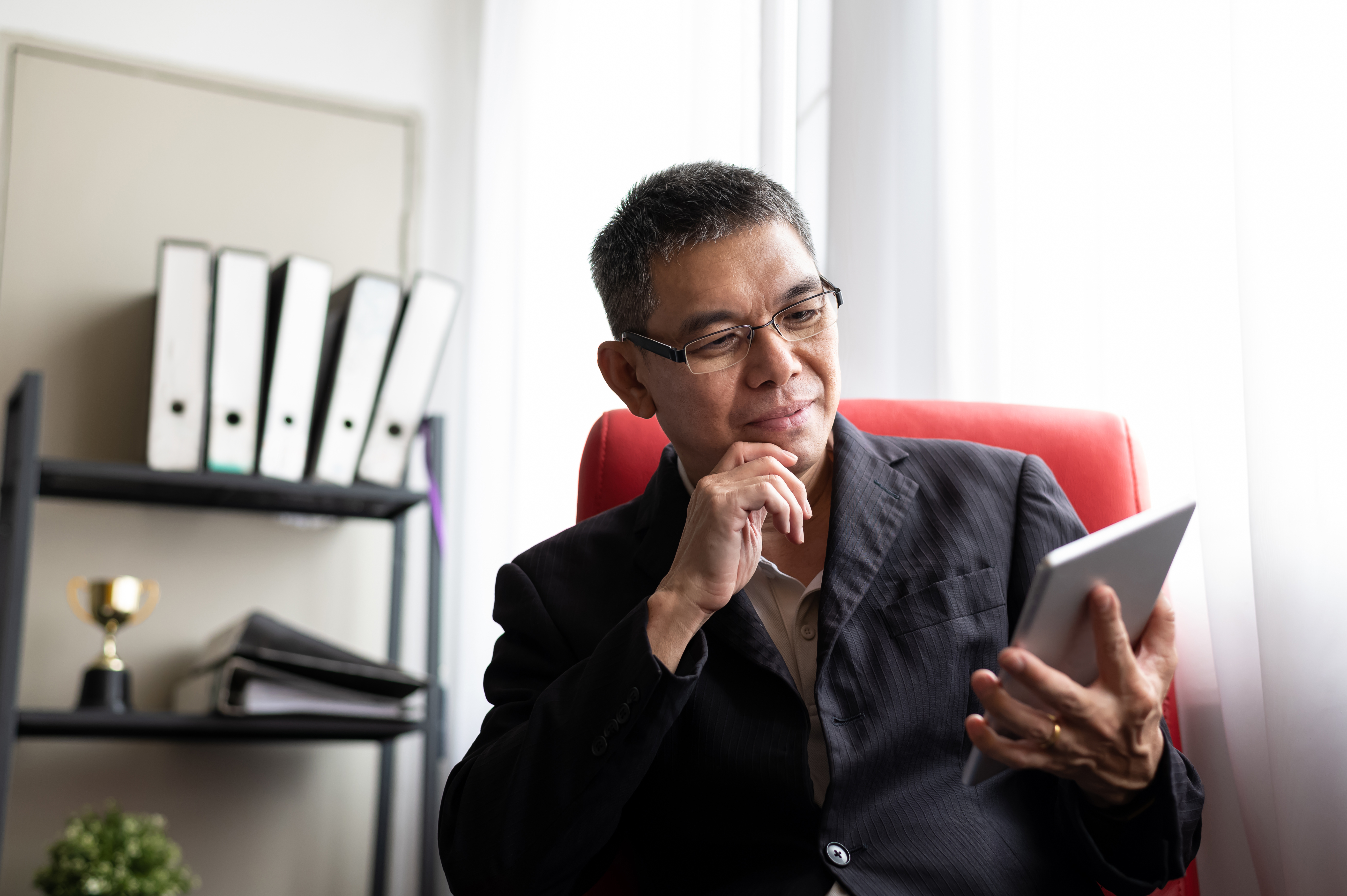 A man checks a tablet computer.