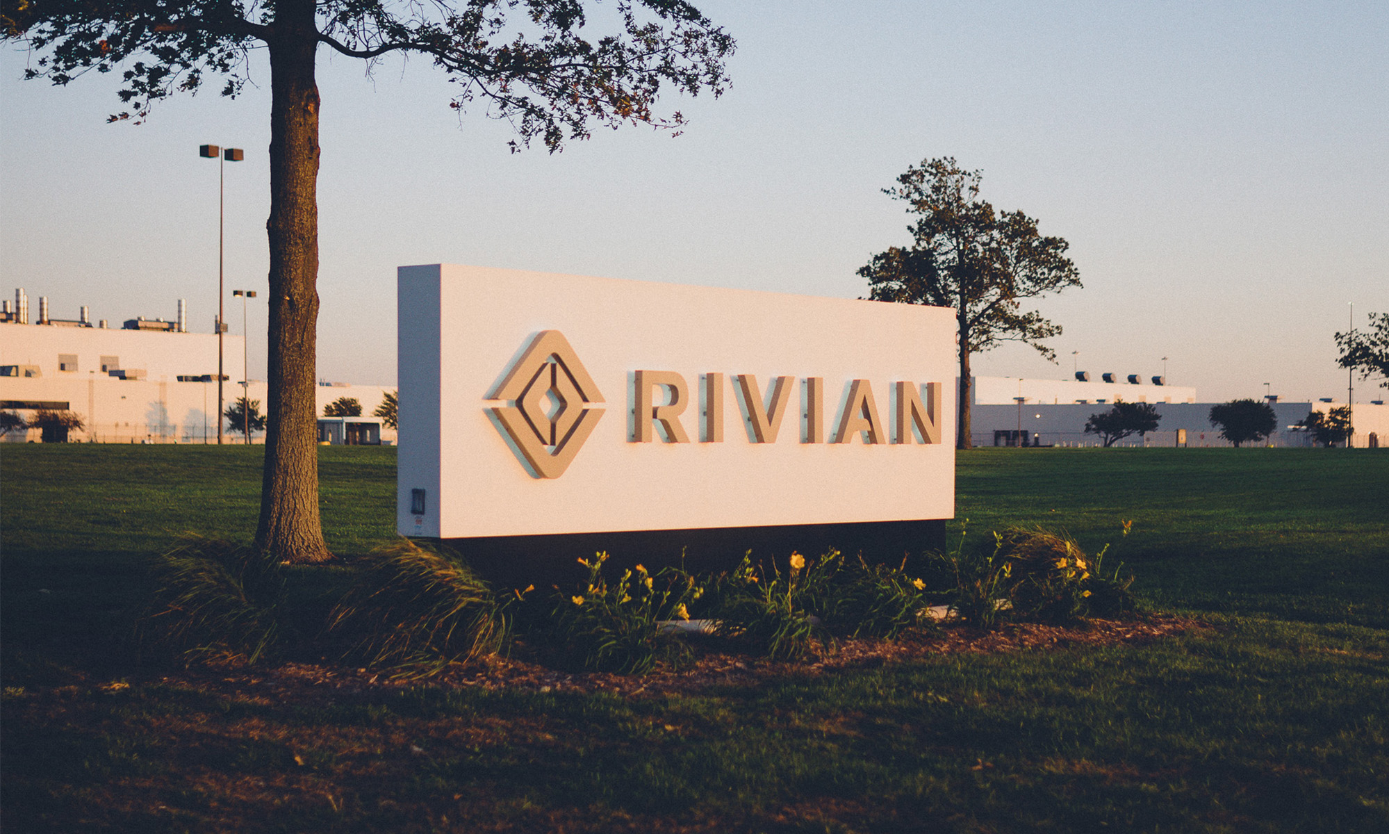 A building with the Rivian logo sign on front lawn.