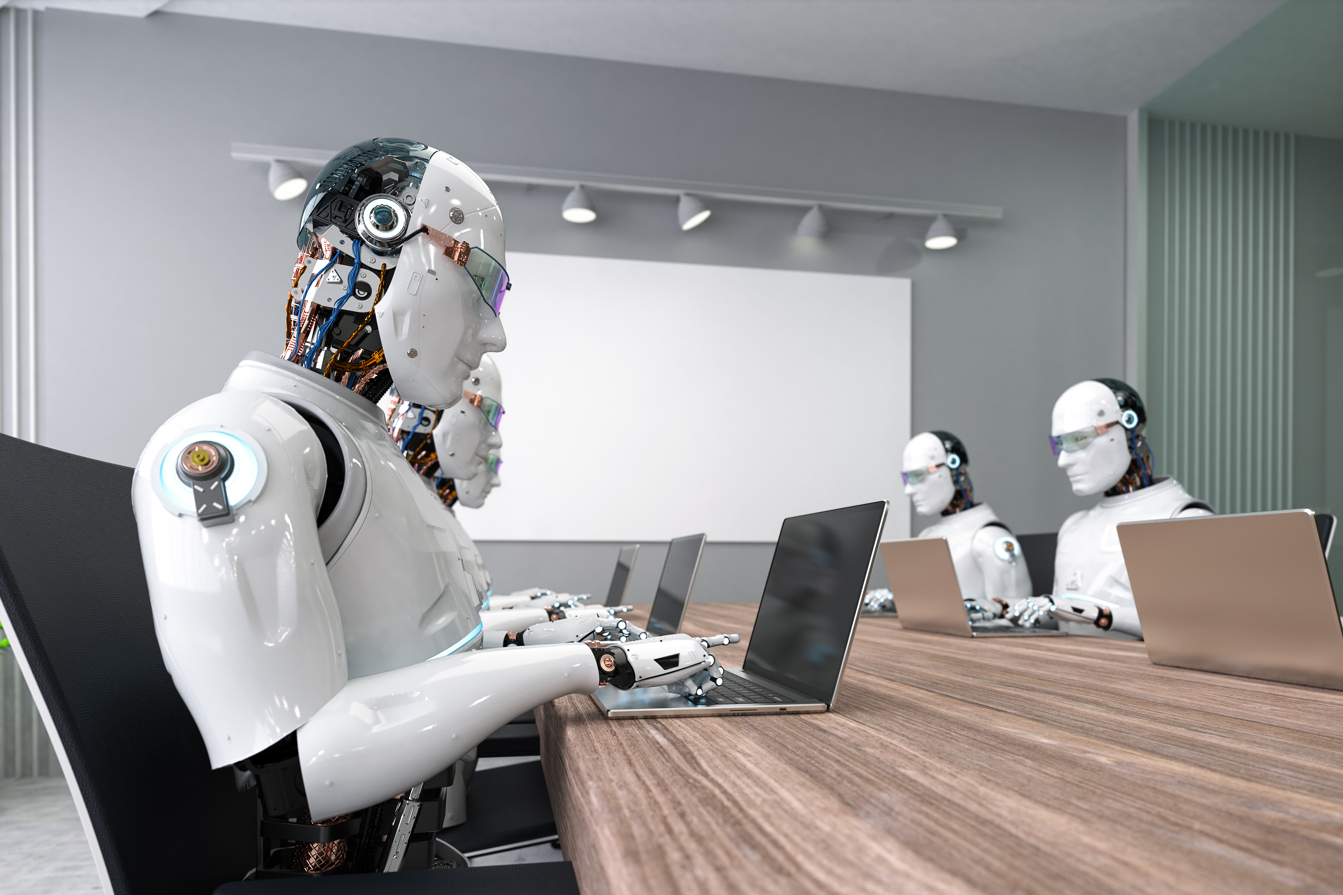 AI robots work on computers in an office.