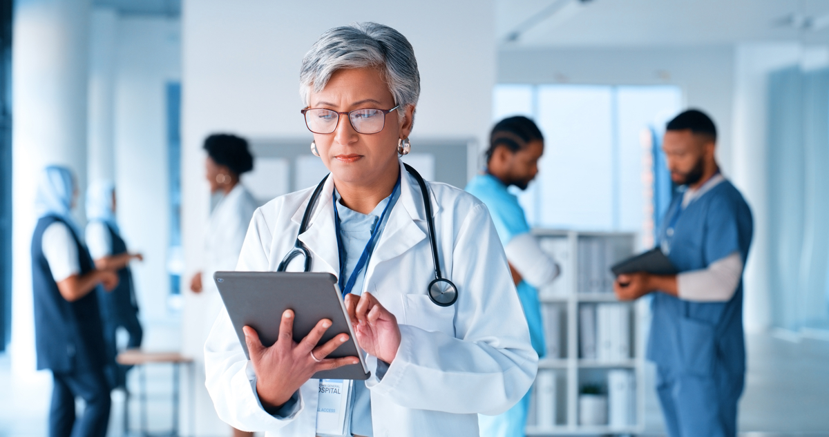 A doctor reviewing notes on a clipboard