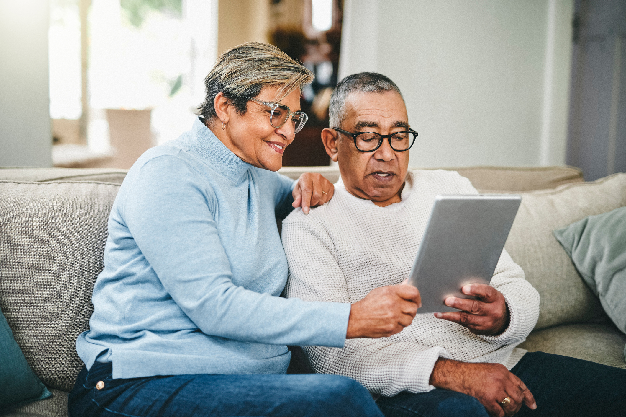 Couple looking at tablet together.