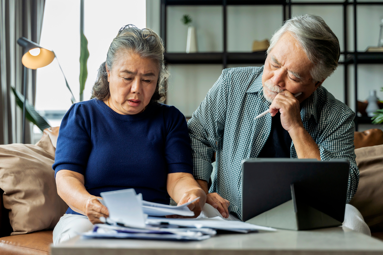 Stressed couple looking at documents together.